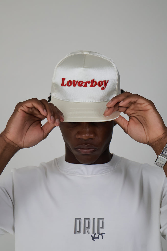 Streetwear fashion model wearing cream white embroidered ‘Loverboy’ cap and minimalist white oversized DRIP KIT t-shirt with bold logo — trendy unisex street style hat and graphic tee for Gen Z and millennial fashion lovers

Satin white off-white baseball heartbreak break-up love gen millennials couples streetwear style fashion sustainable eco-friendly vacation daily essentials Gen Z cap hat bold statement luxury cool summer clothing trend outfit OOTD Instagram designer dripkit eco-fashion streetwear 

